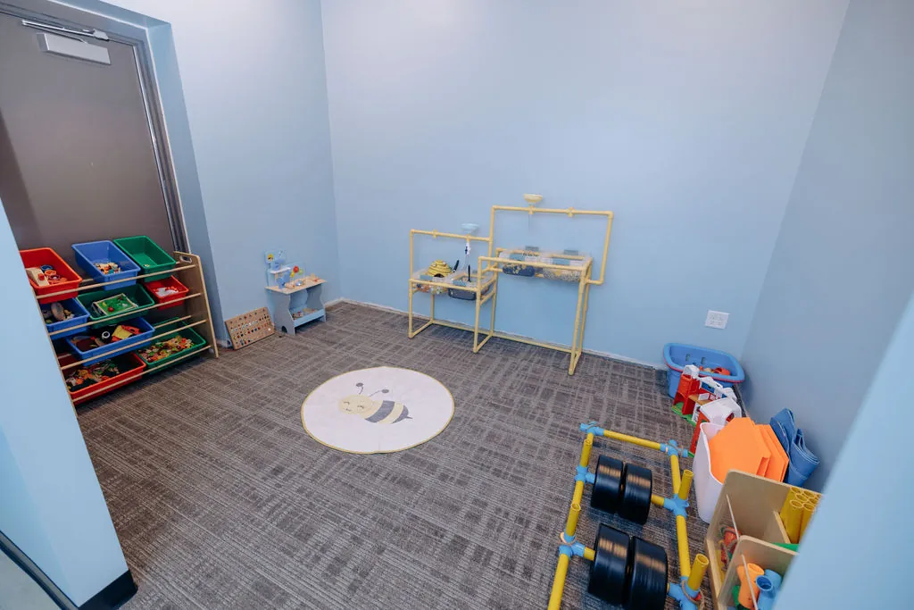 Fine motor room with pretend play and sensory bins at Bee Me